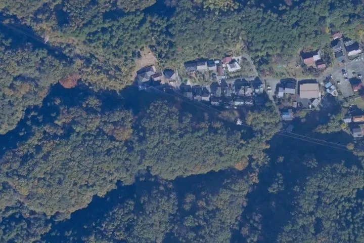 Map view of a wooded area with buildings captured from aerial survey data